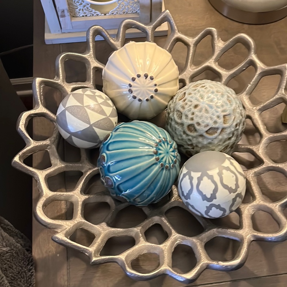 Metal decorative bowl with assorted ceramic and wood balls